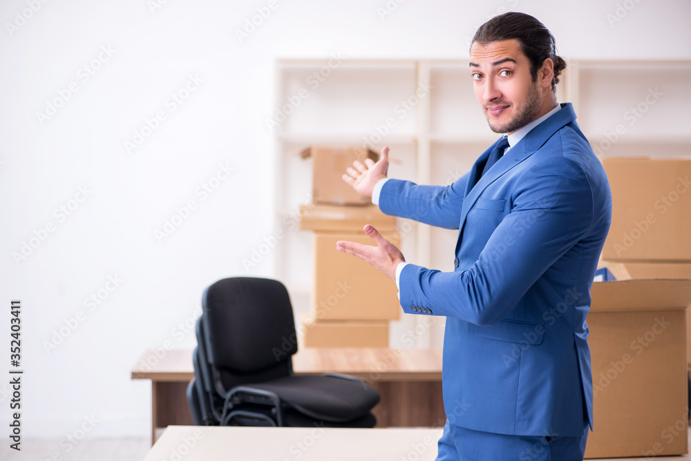 Young male employee in relocation concept
