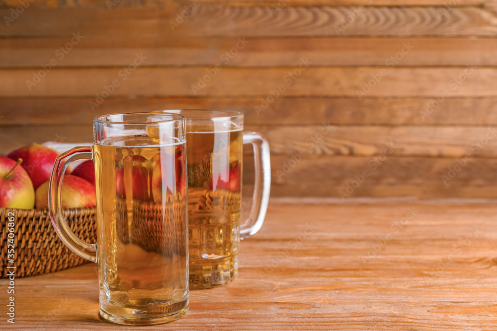 Mugs of apple cider on wooden background Mugs of apple cider on wooden background