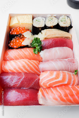 Various kinds of fresh sushi set in wooden box