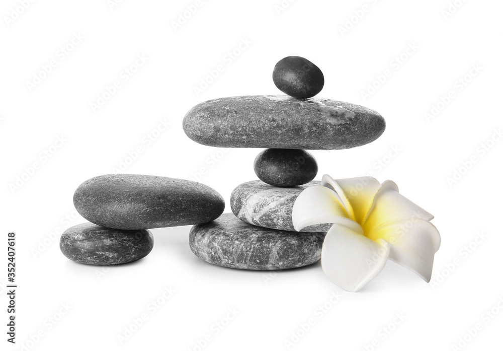 Fototapeta premium Stack of zen stones and flower on white background