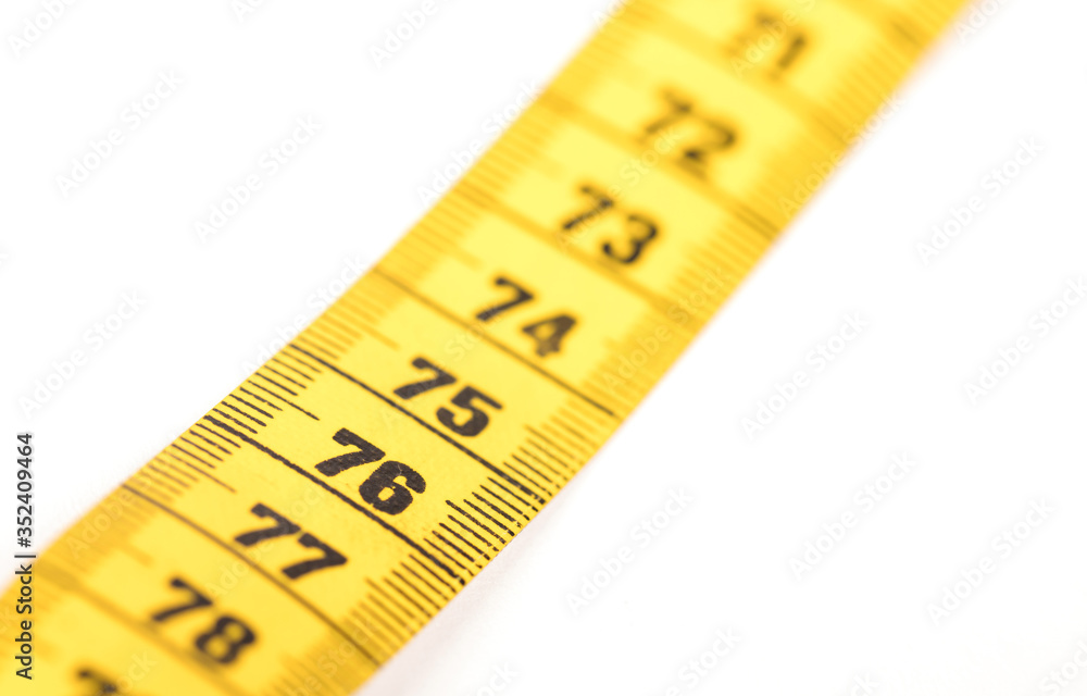Close-up of a yellow measuring tape isolated on white - 76 Close-up of a yellow measuring tape isolated on white - 76