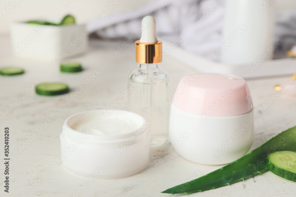 Cosmetics with cucumber extract on table Cosmetics with cucumber extract on table