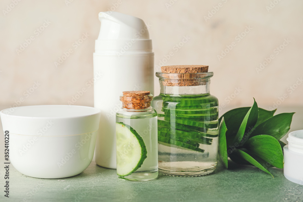 Cosmetics with cucumber extract on table Cosmetics with cucumber extract on table