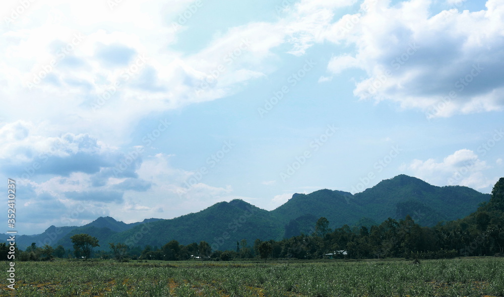 Fototapeta premium Views of mountains, fields and clouds sky