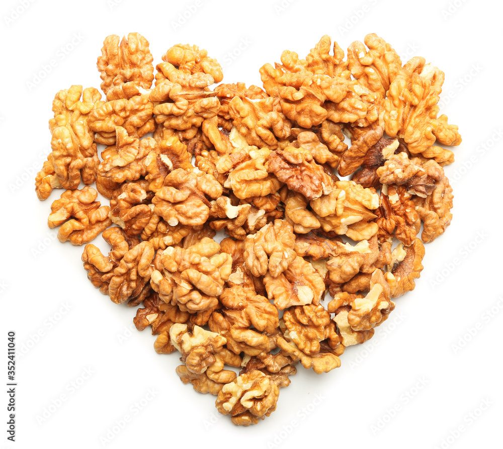 Heart made of tasty walnuts on white background Heart made of tasty walnuts on white background
