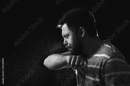 Coughing man on dark backgr...