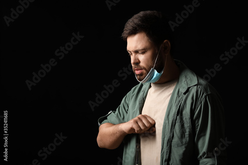 Coughing man on dark backgr...