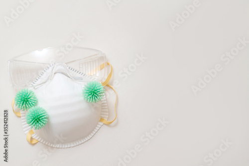virus bacteria on medical mask with protective glasses top view