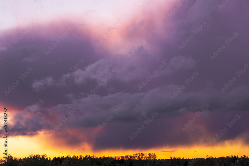 Fototapeta premium Dramatic thunder clouds at sunset in spring