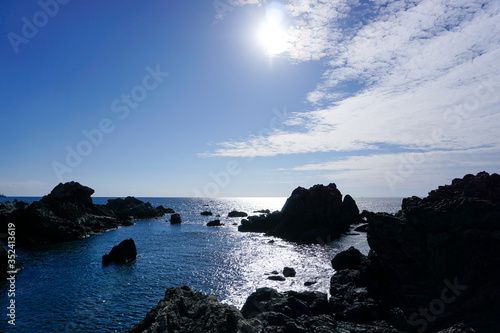 Blue sky and rocky shore