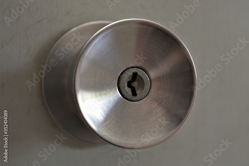 a metal door knob with key lock