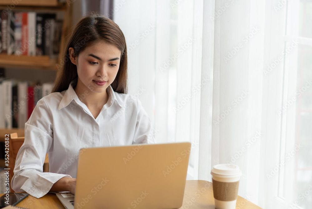 Young Asian businesswoman working at her house with laptop, working at home, business concept Young Asian businesswoman working at her house with laptop, working at home, business concept