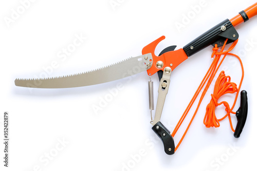 pruning saw and pruning shears isolated on white background. Scissors, pulling with rope.