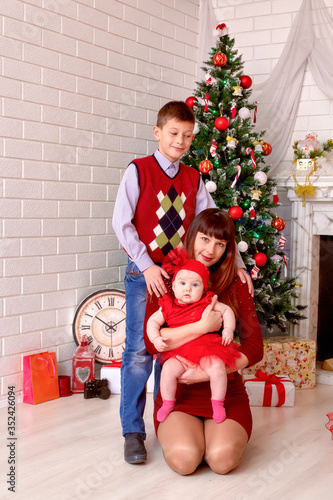 Happy young mother with her son and baby girl for Christmas in home traditions © Marina Shvedak