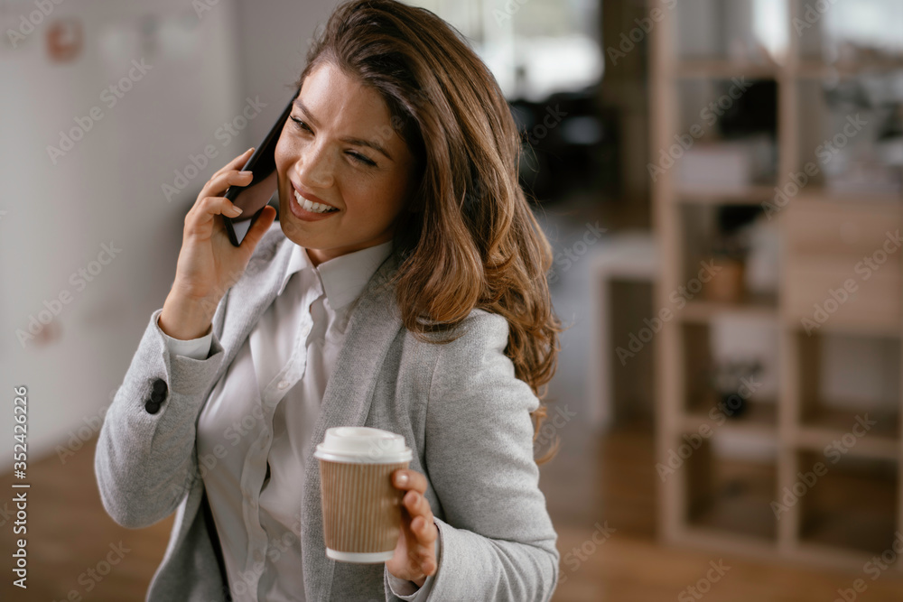 Businesswoman talking to the phone. Happy young woman working in office. Businesswoman talking to the phone. Happy young woman working in office.