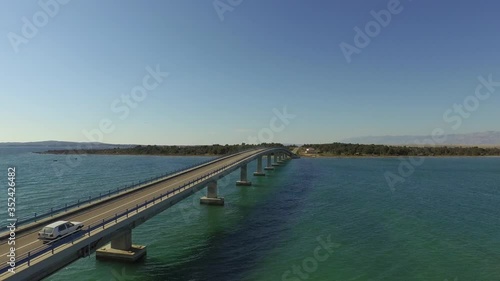Wallpaper Mural Aerial shot of vehicle on car over sea against blue sky, drone flying forward over ocean on sunny day - Razanac, Croatia Torontodigital.ca