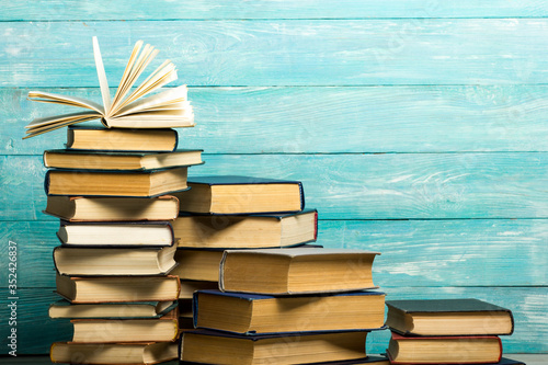 Open book, hardback books on wooden table. Back to school. Copy space