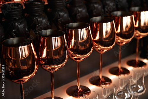 gold metal wine glass, dark background