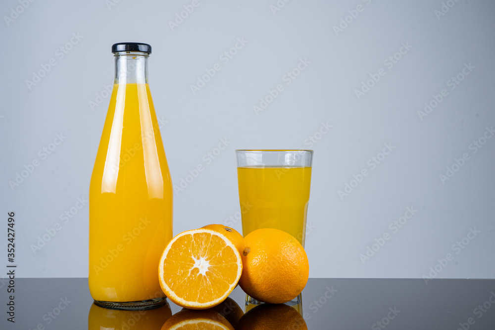 Bottle of orange juice and oranges Bottle of orange juice and oranges