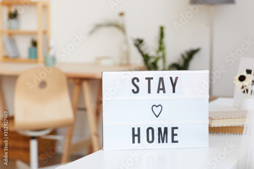 Wallpaper Mural Image of poster with text Stay home on the table in the room Torontodigital.ca