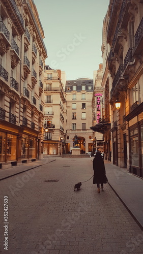 Woman walking her dog in the street of Paris