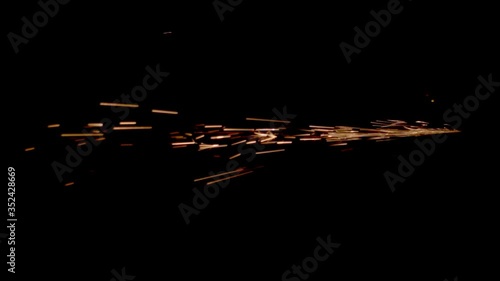 Fiery sparks fly from one point on a black background