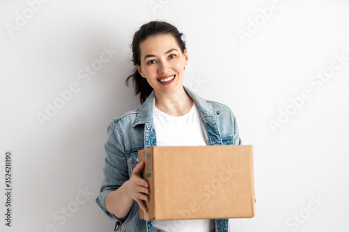 Happy woman with cardboard box. © Konstantin Yuganov