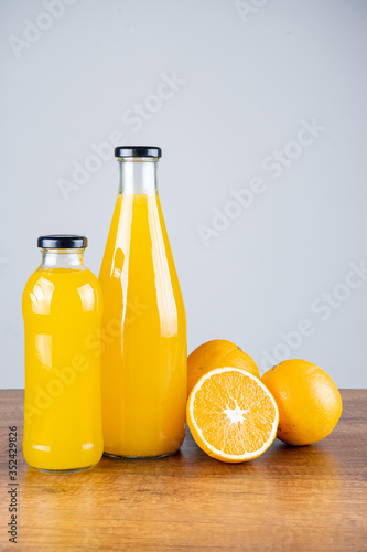 Bottle of orange juice and oranges