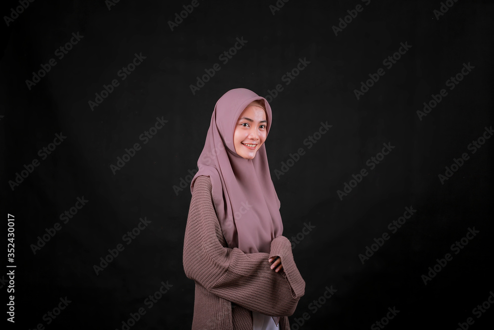 Portrait of Young Asian Islam woman wearing headscarf looking at camera and smiling happy expression Portrait of Young Asian Islam woman wearing headscarf looking at camera and smiling happy expression