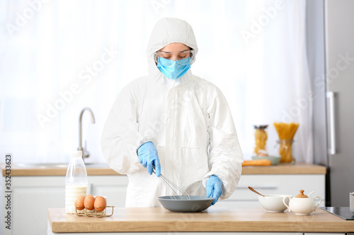 Woman in biohazard suit coo...