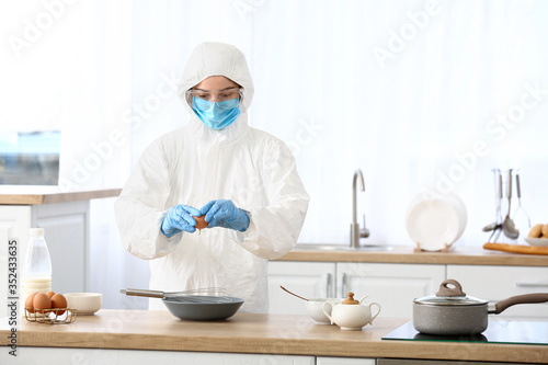 Woman in biohazard suit coo...