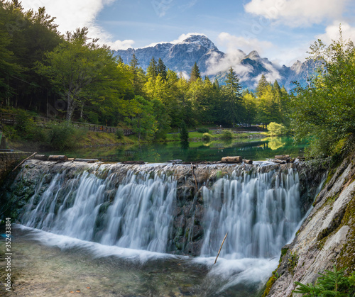 small waterfall on a stream flowing out of Lake Laghi di Fusine in the Julian Alps in Italy