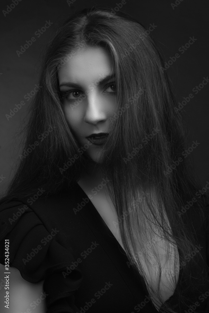 Black and white portrait of young fat girls brunette with long hairblack dress with sweetheart neckline