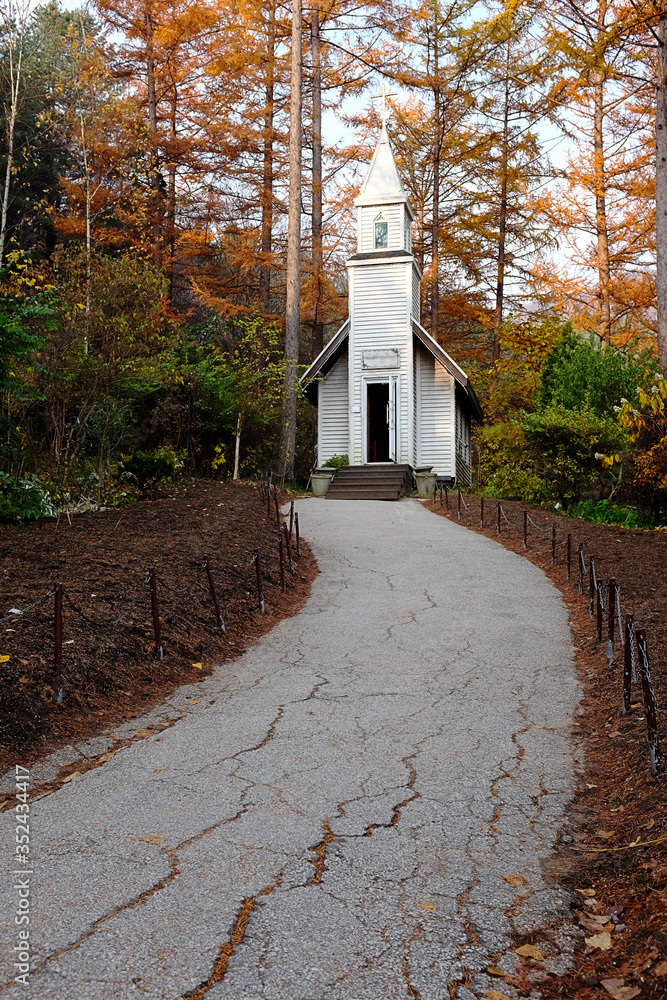 A church at the end of a path in a mountain.