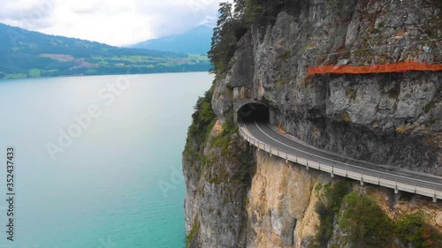 Aerial footage of a mountain road with a tunnel, interlaken, Swiss countryside,  Alps, summer photo