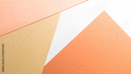 Color papers geometry shape composition background with white beige copper and brown color tones. Minimalism geometric flat lay backdrop.