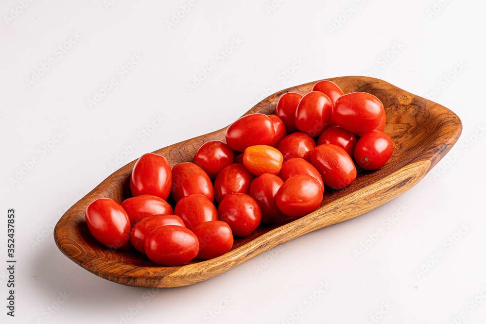 cherry tomatoes on wooden plate