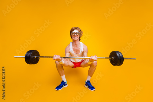 Full length body size view of nice funky motivated weak guy lifting barbell doing work out coacher trainer program regime body building isolated over bright vivid shine vibrant yellow color background photo