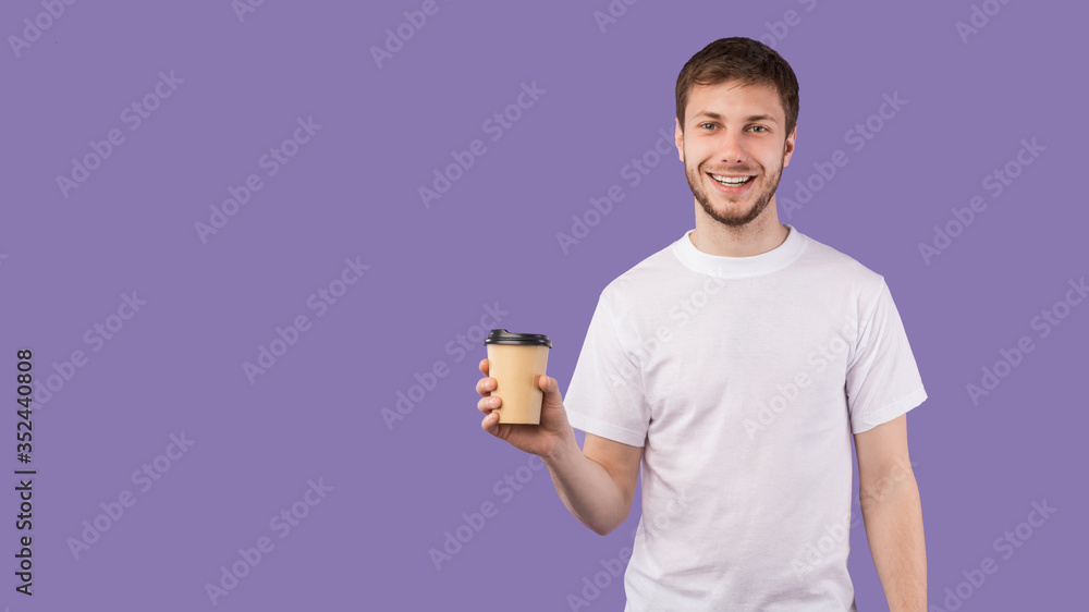 Portrait of cheerful youth holding hot beverage Portrait of cheerful youth holding hot beverage