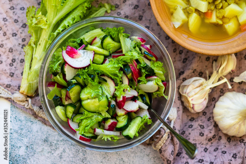 Fresh vegetables salad - radish, lettuce, cucumber, salad leaves. Vegan healthy food