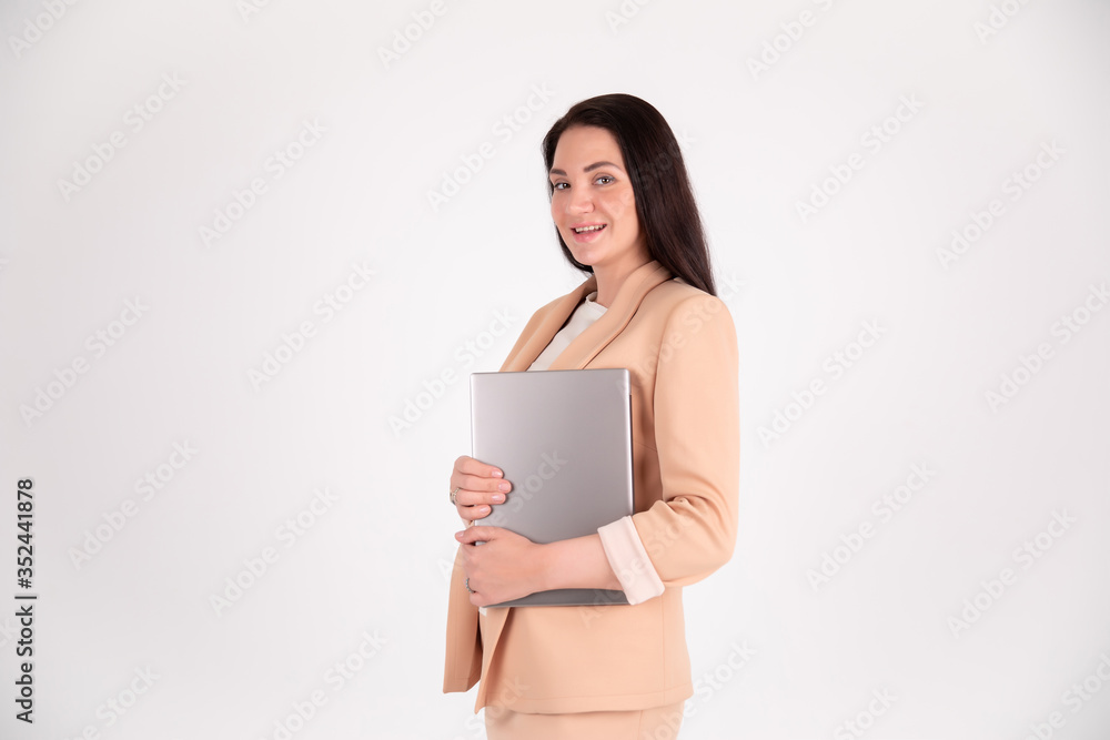 Successful business woman on grey background with copy space. Director in strict suit with laptop Successful business woman on grey background with copy space. Director in strict suit with laptop