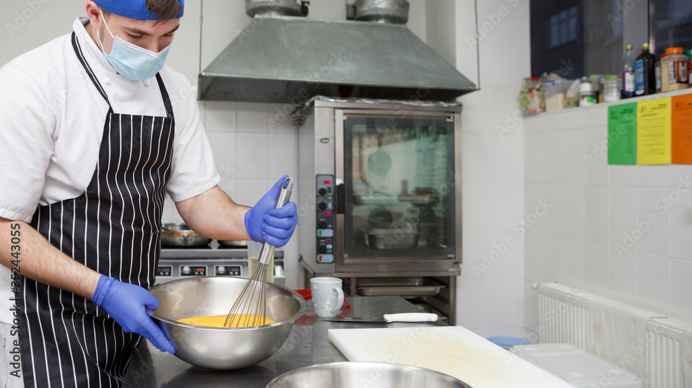 Man beating eggs with a whisk on take away kitchen Man beating eggs with a whisk on take away kitchen