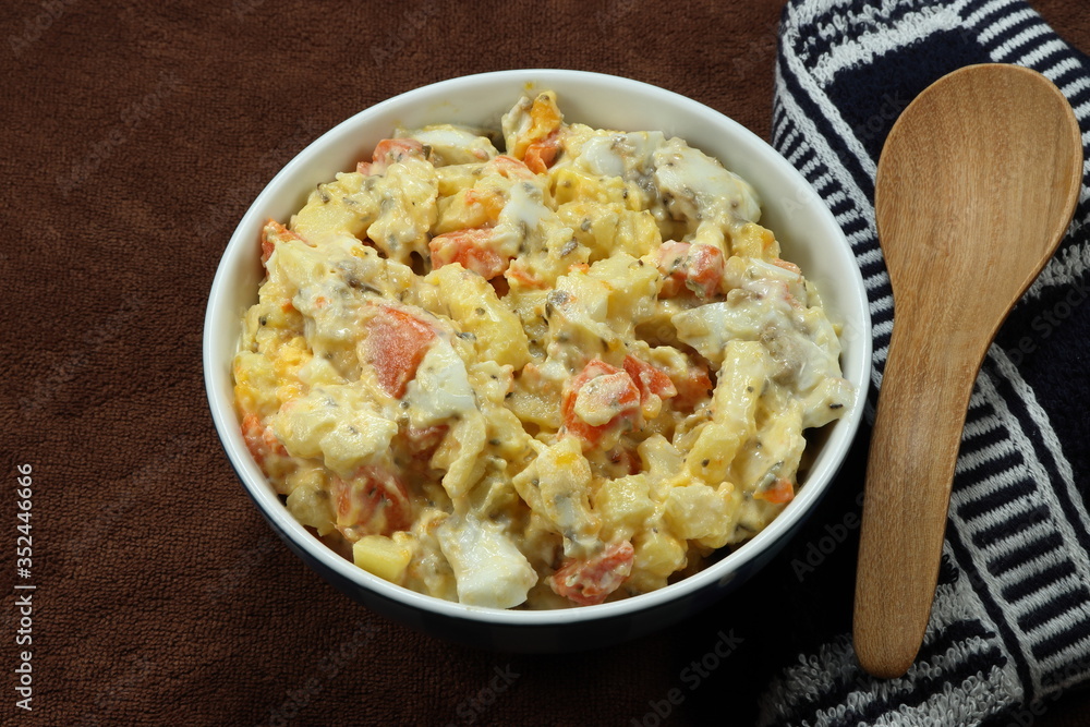 Traditional potato salad with boiled chicken egg and fresh carrot seasoning with mayonnaise cream on the bowl. Famous healthy comfortable breakfast in the morning. Low fat and high nutrition food. Traditional potato salad with boiled chicken egg and fresh carrot seasoning with mayonnaise cream on the bowl. Famous healthy comfortable breakfast in the morning. Low fat and high nutrition food.