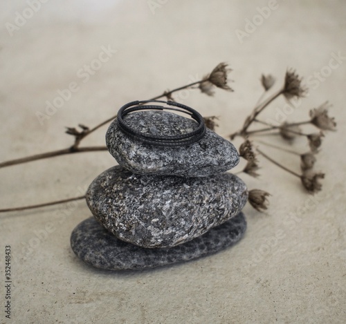 Stones stacked with jewellery on top. Jewellery photography. 