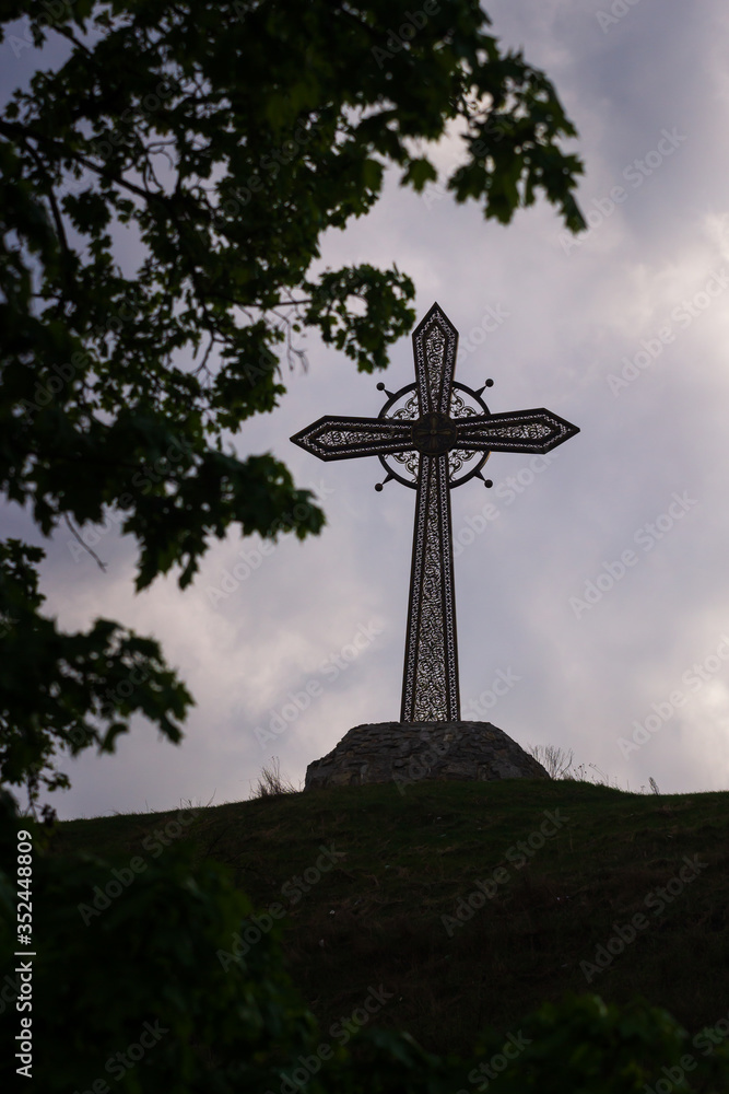 Big Iron cross and Kamianets-Podilskyi Castle, Ukraine.