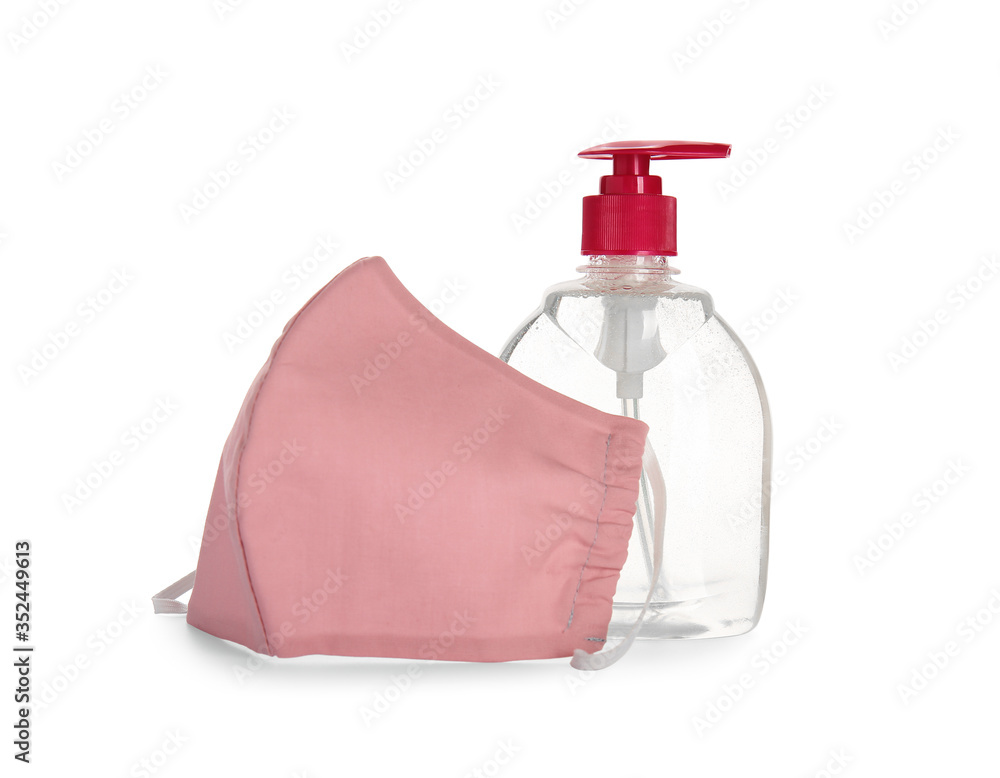 Bottle of disinfectant and medical mask on white background Bottle of disinfectant and medical mask on white background