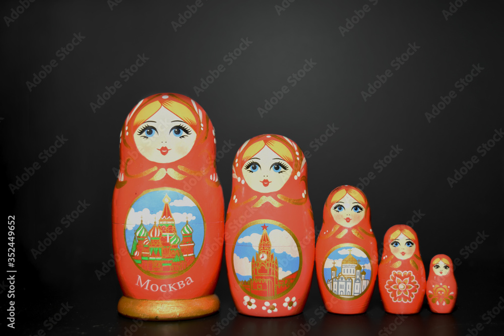 five russian dolls on a black background