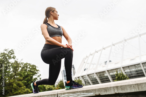 Female lower body workout. Slim and athletic girl doing lunges outdoors © Vadim Pastuh