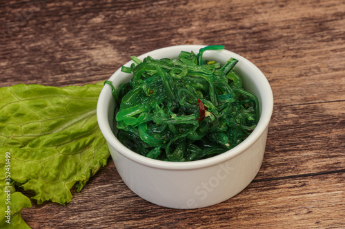 Green Chuka Seaweed Salad Isolated on White Background Top View. Wakame Sea Kelp Salat