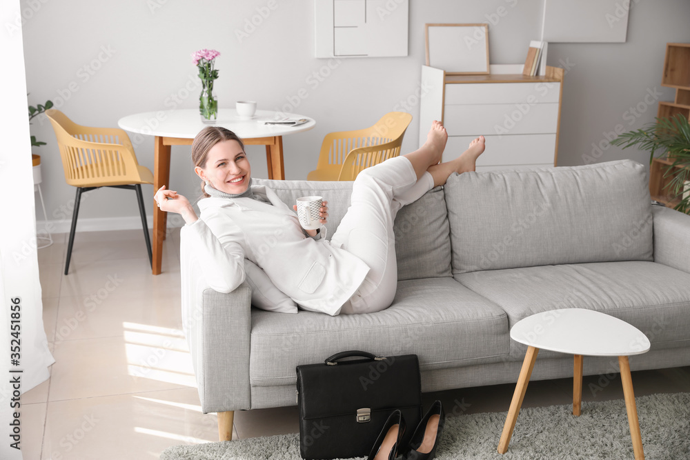 Businesswoman relaxing on sofa after work at home Businesswoman relaxing on sofa after work at home